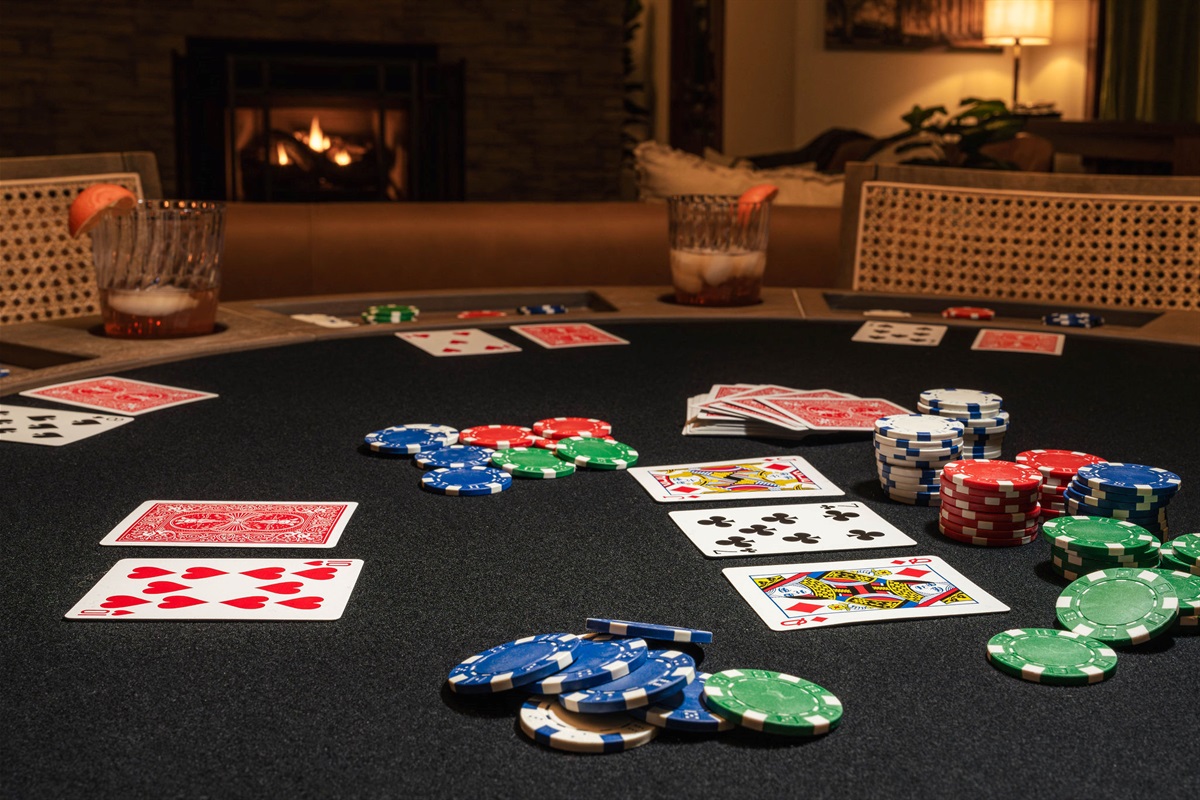 Everything you need for a classic game night — cards, chips, atmosphere, and a cozy fireside setting.