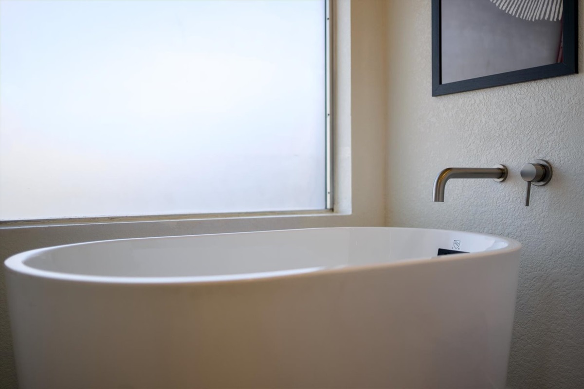 Main ensuite bathroom has separate shower and soaking tub.