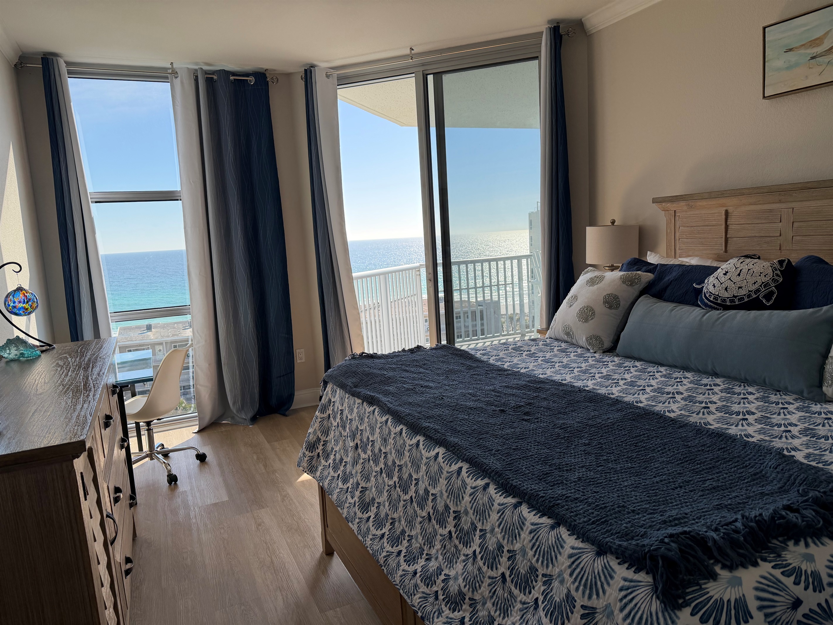 Master bedroom, access to balcony and beautiful Gulf view facing east. Black out curtains ensure ample rest.