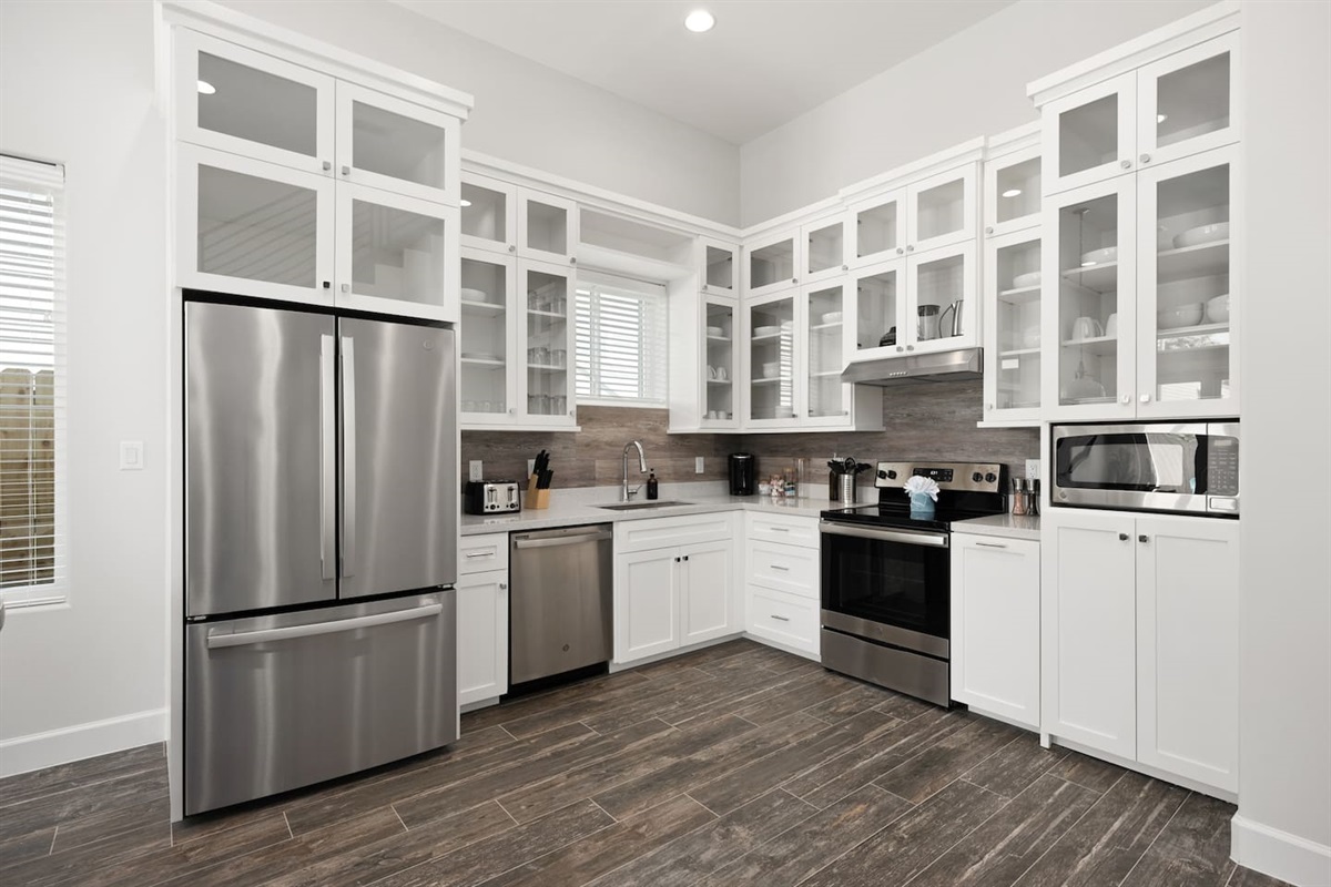 Kitchen area with stove, refrigerator, oven