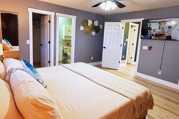 Spacious master suite with a plush king bed, en-suite bathroom, and cozy ambiance for a relaxing stay.