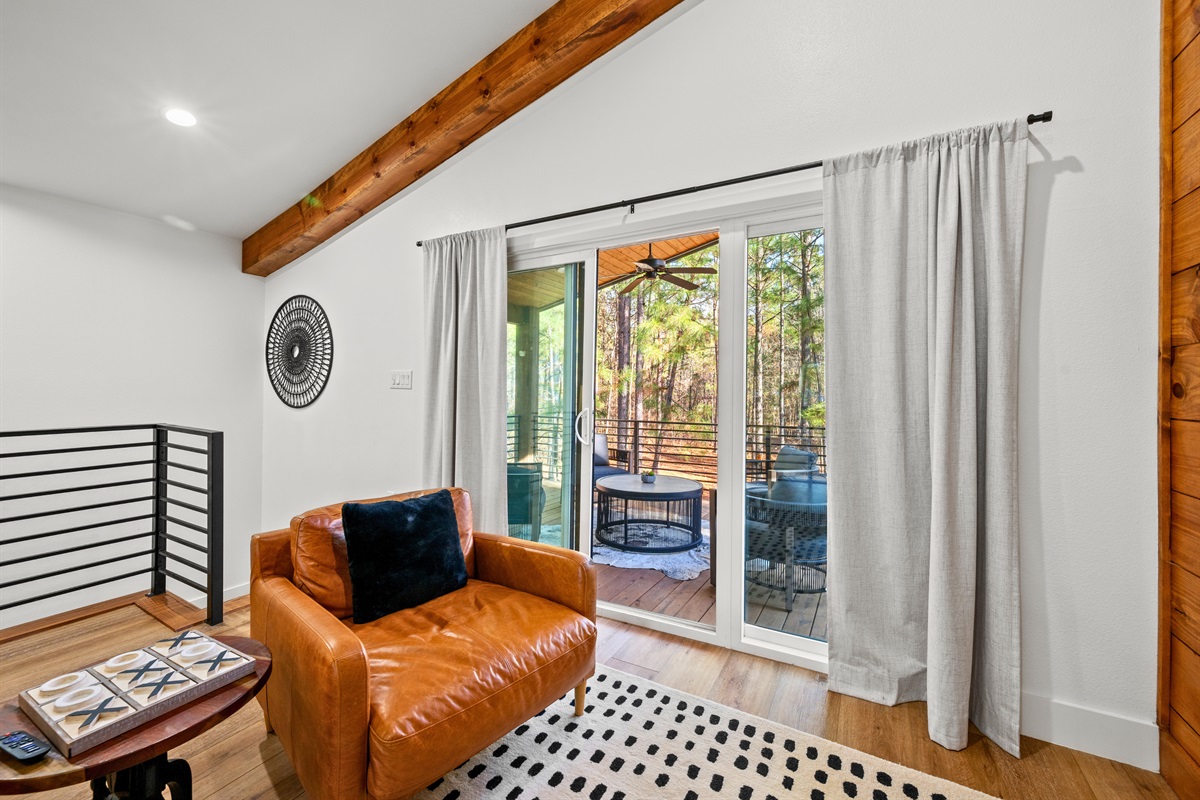 This cozy seating nook in the loft is filled with natural light and offers peaceful views of the surrounding trees.