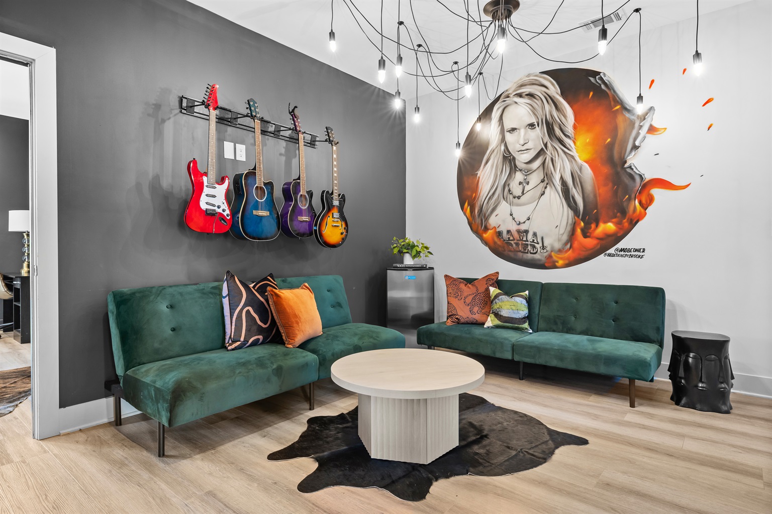 2nd Living Room: Experience Nashville's vibe with vintage guitars and vibrant decor in a stylish hangout with 2 futons for extra sleeping spaces!