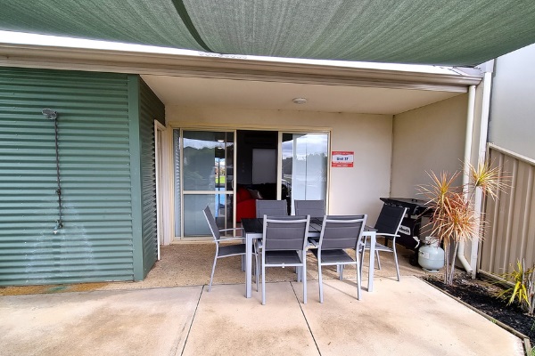 Outdoor dining for 6 people, with large shade sail and includes gas BBQ under main roof (this area faces the street)