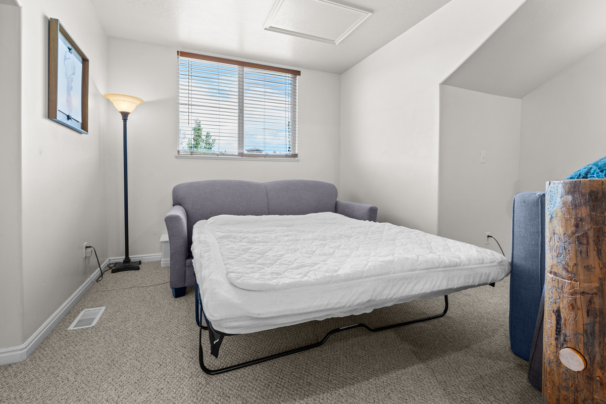 The primary bedroom also includes a sleeper sofa, offering added flexibility and comfort for additional guests.