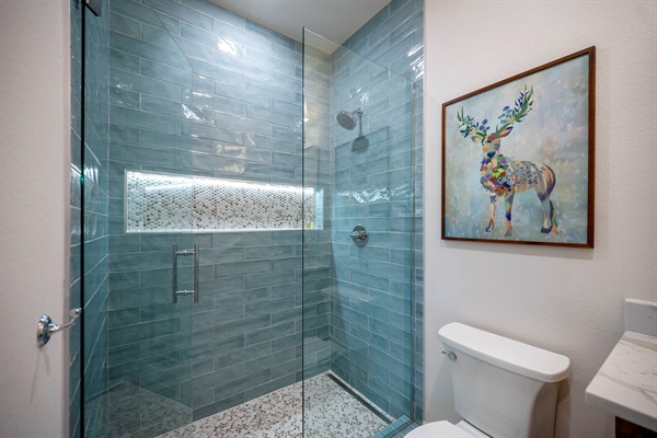 A soothing walk-in shower with glowing niche lighting and nature-inspired touches. 🌿💧