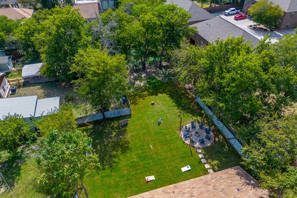 Private green backyard with fire pit and lawn games ready for outdoor fun