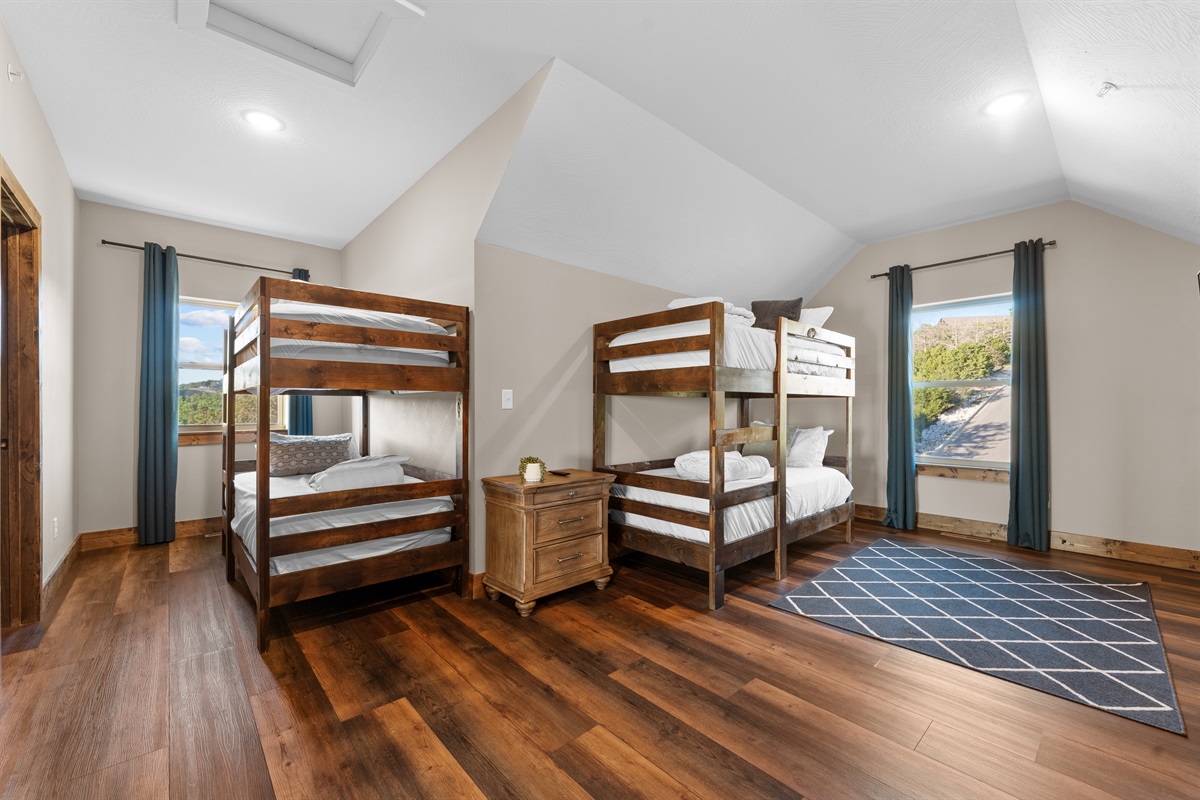 Big windows and natural light keep the bunk room bright and welcoming.