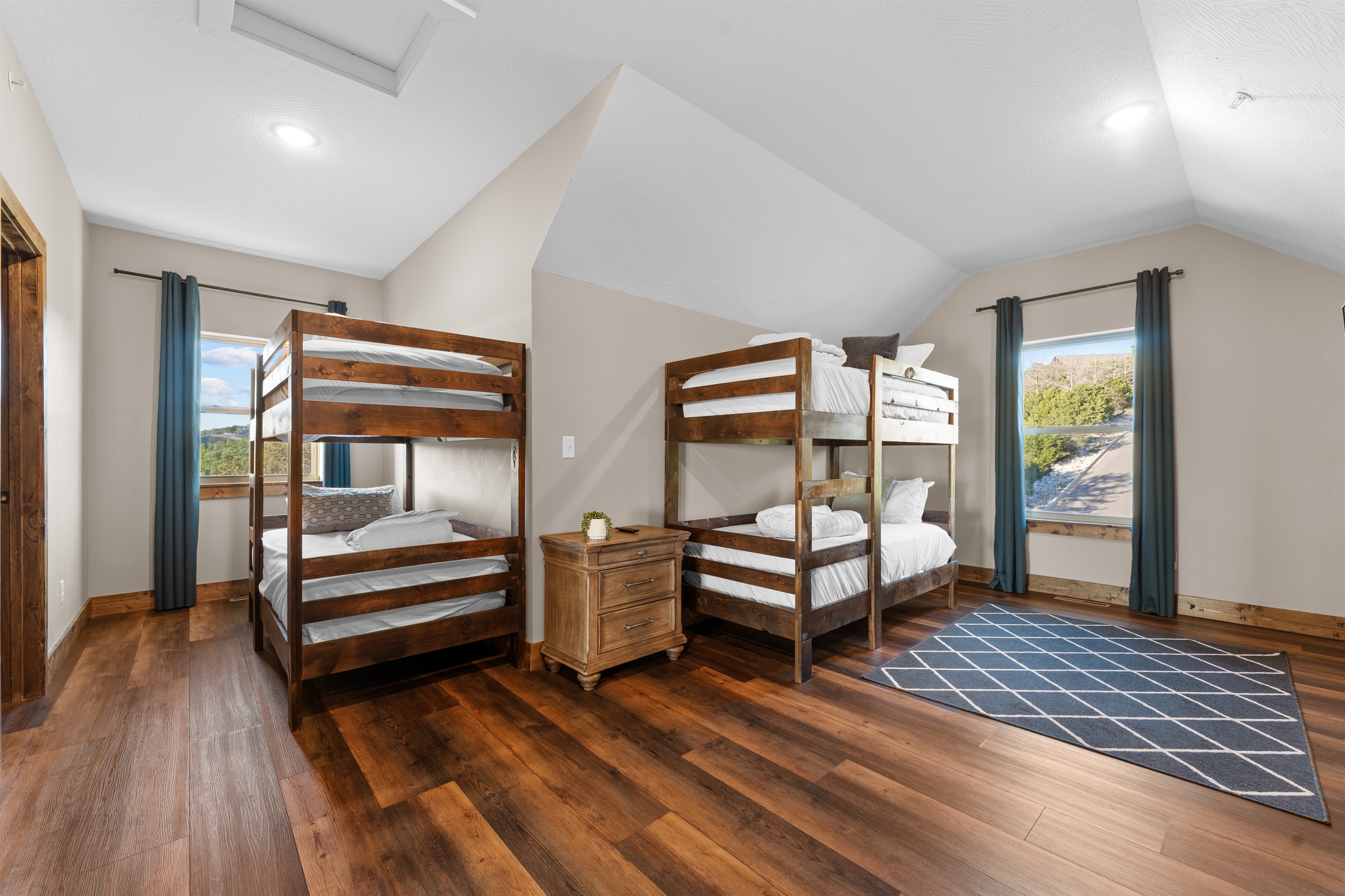 Big windows and natural light keep the bunk room bright and welcoming.