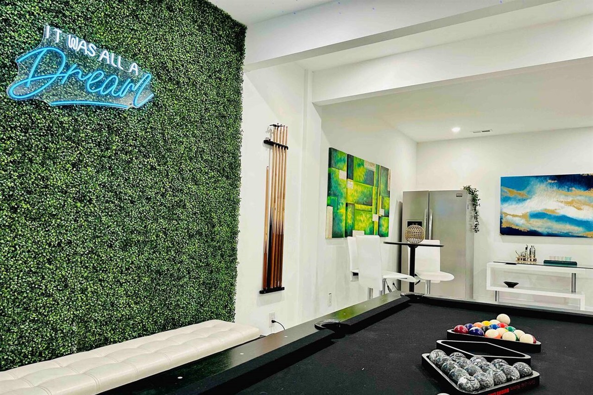 White-themed room, featuring a beautiful snooker table and elegant dining area for the perfect blend of relaxation and entertainment.