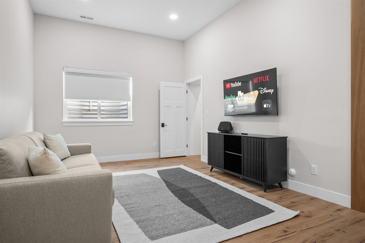 Lower-Level Bedroom 2 featuring lounge space and Smart TV — perfect for teens or movie nights.