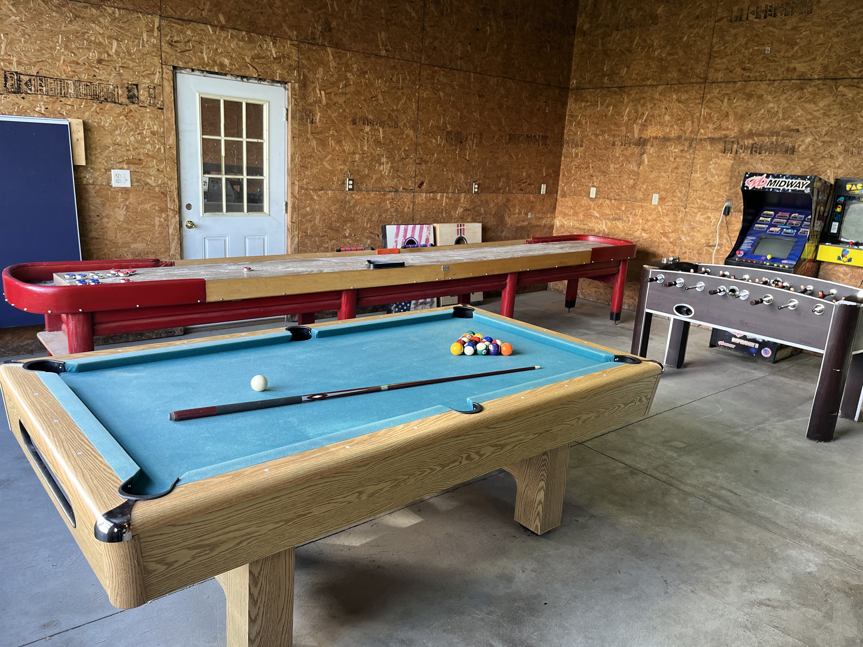 Roundtripper game room with sectional couch seating and games.