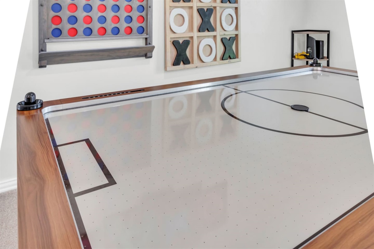 Games galore! Make memories in this dedicated game room, adorned with a full sized hockey and foosball table .