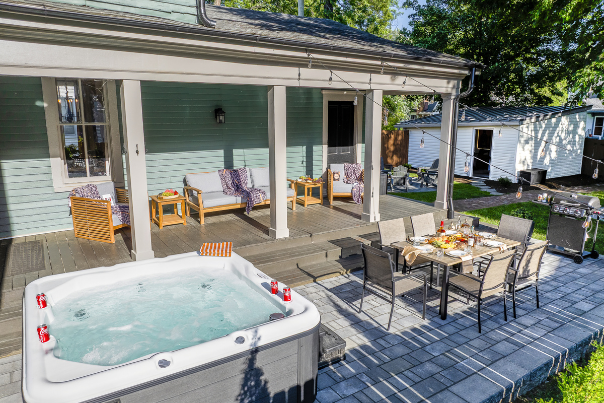 Hot tub, covered dining, a fire pit, string lights, and a game lawn come together to create the ultimate backyard retreat.