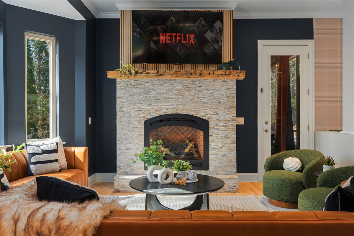 Modern living room with fireplace and natural light - clean, design-forward interiors throughout the home