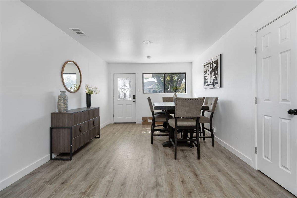Spacious dining room in the heart of the home. Enjoy meals, game nights, or remote work with a clear view of the living room and kitchen.