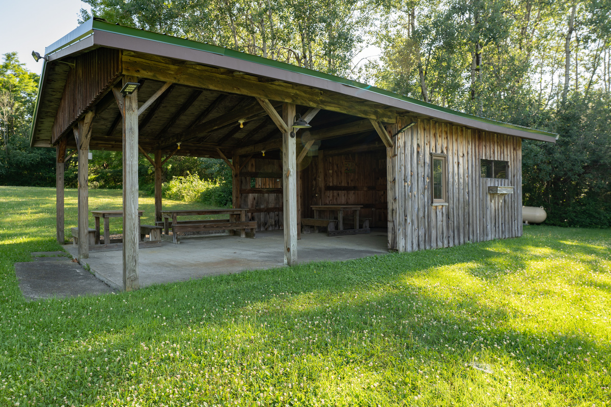 Covered open-sided structure beside the lawn