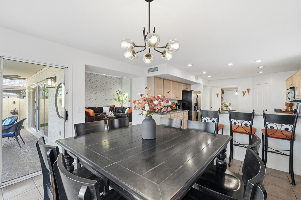 Dining area with table seating, patio access, and open flow to the kitchen and living room for easy meals or gathering.