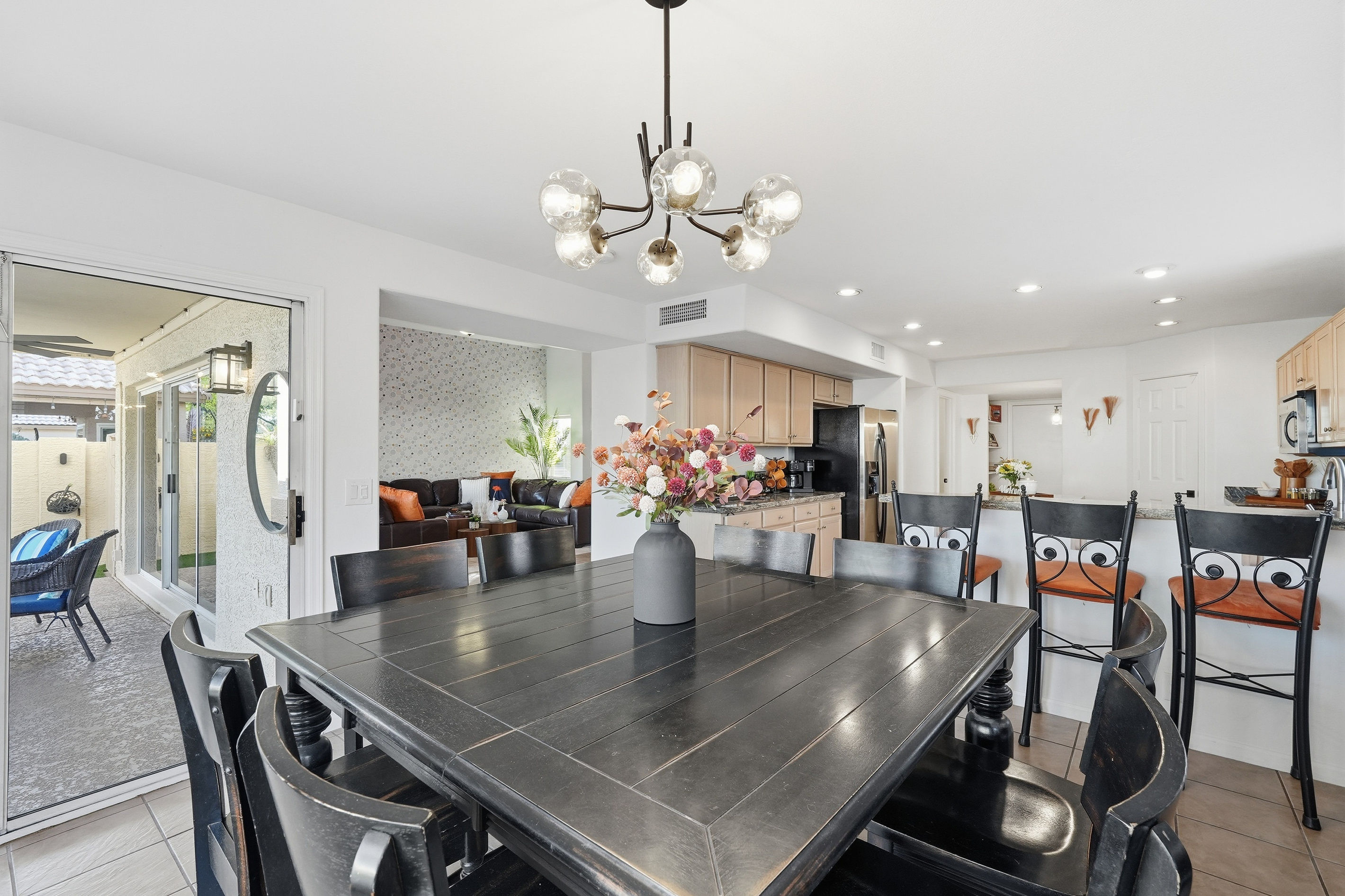 Dining area with table seating, patio access, and open flow to the kitchen and living room for easy meals or gathering.