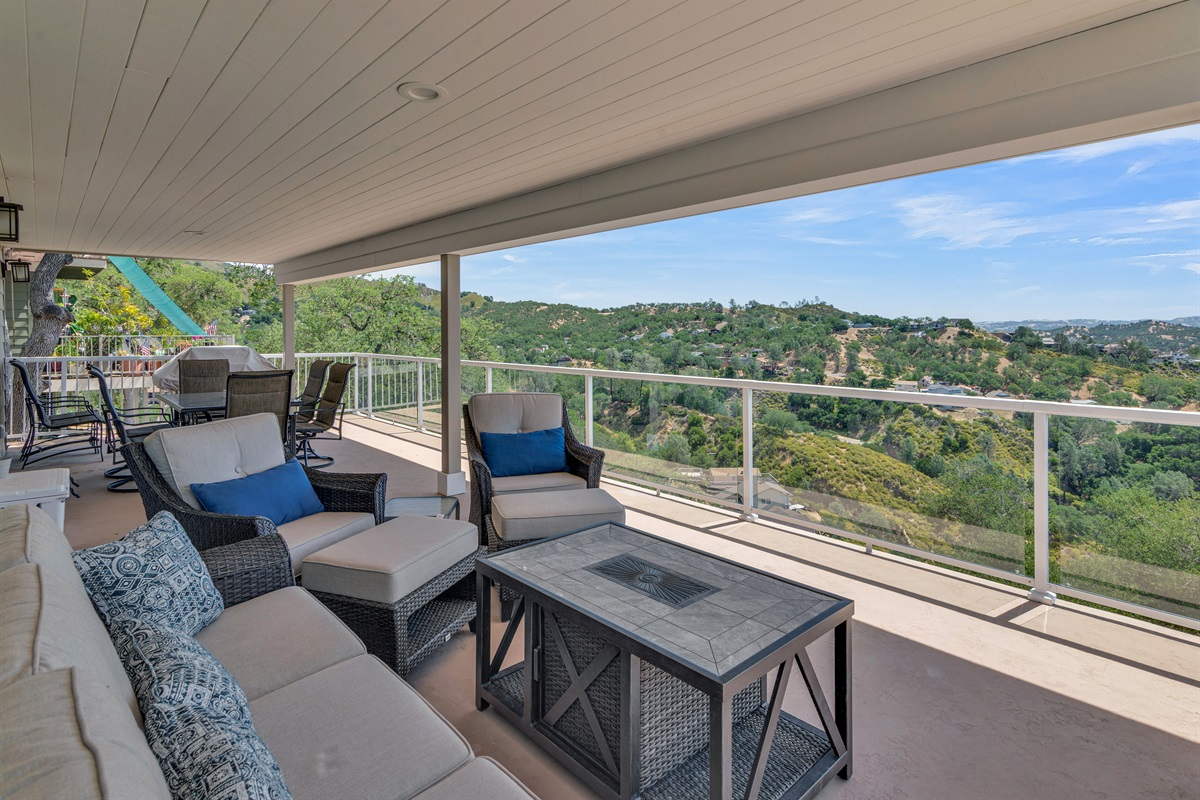 Lounge on the shaded patio with exquisite furniture, fire pit and panoramic views of the lake and mountains.