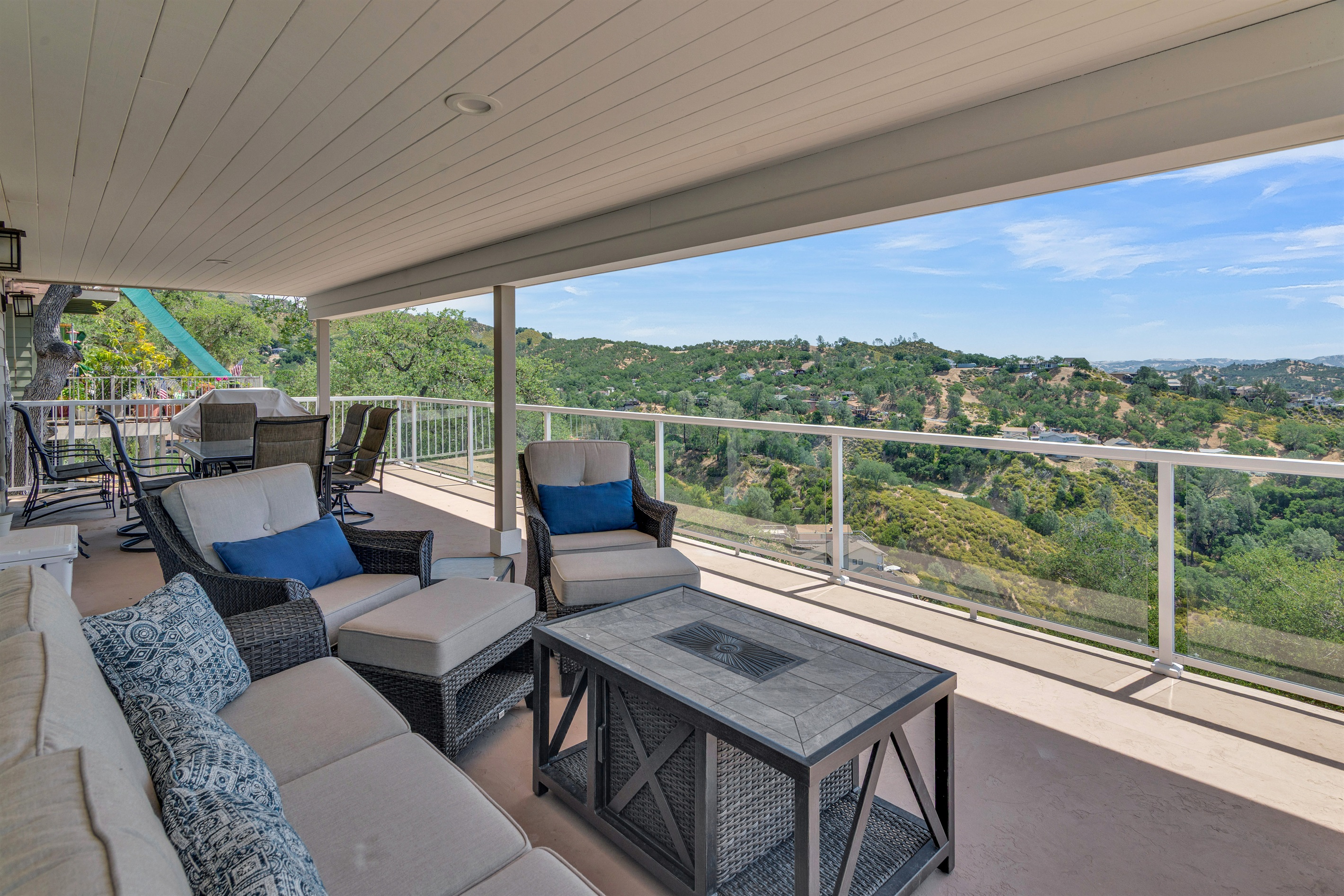 Lounge on the shaded patio with exquisite furniture, fire pit and panoramic views of the lake and mountains.