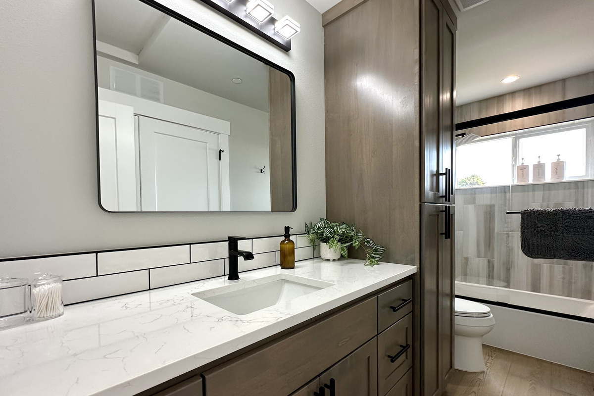 Crisp white subway tile, quartz counters and matte black fixtures — with three full baths, mornings never back up here.