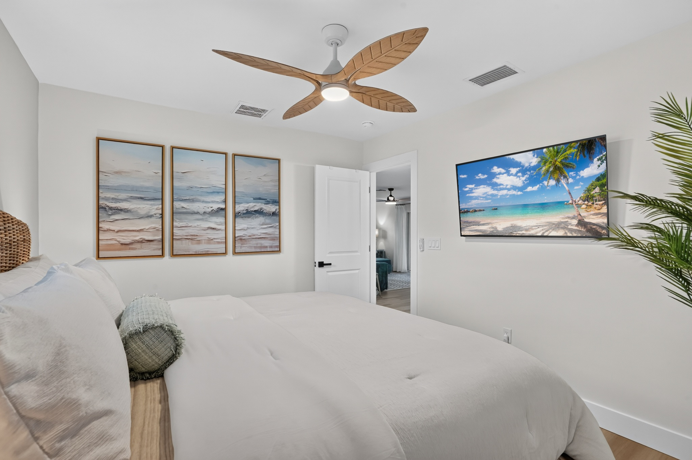 The second bedroom combines a new king mattress, coastal décor and a 50-inch smart TV.
