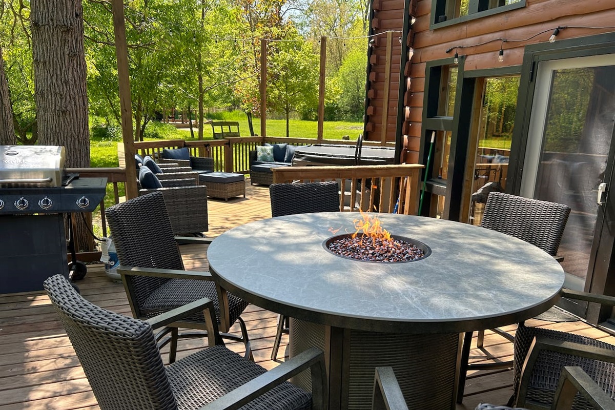 Make a delicious meal on the propane grill to eat at the outdoor dining area that seats 6 people and has a fire feature in the center of the table.