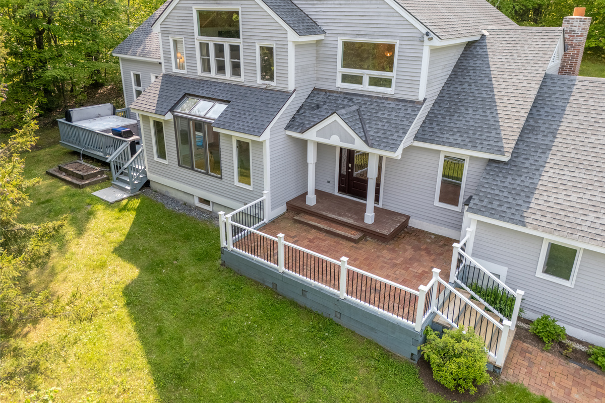 Covered front porch and side deck at this Stratton Mountain vacation rental in Winhall, Vermont