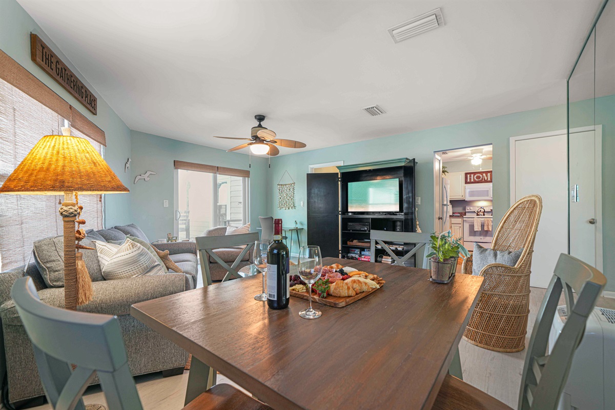 Everything flows at The Gathering Place — dining for 4, the queen sleeper sofa, entertainment center, and the deck all in one open space.