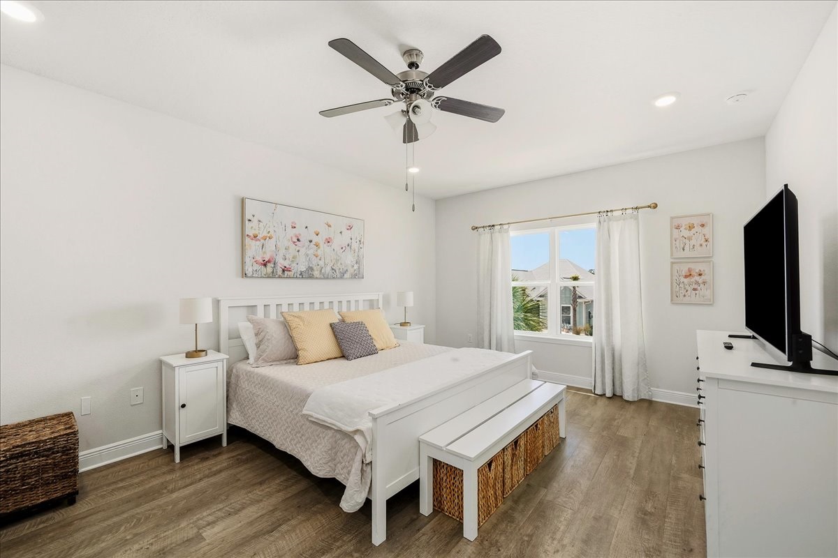 Primary Suite: Enjoy restful nights in a King bed with cozy linens, Smart TV, ceiling fan, convenient storage, and room-darkening shades to help you sleep in.