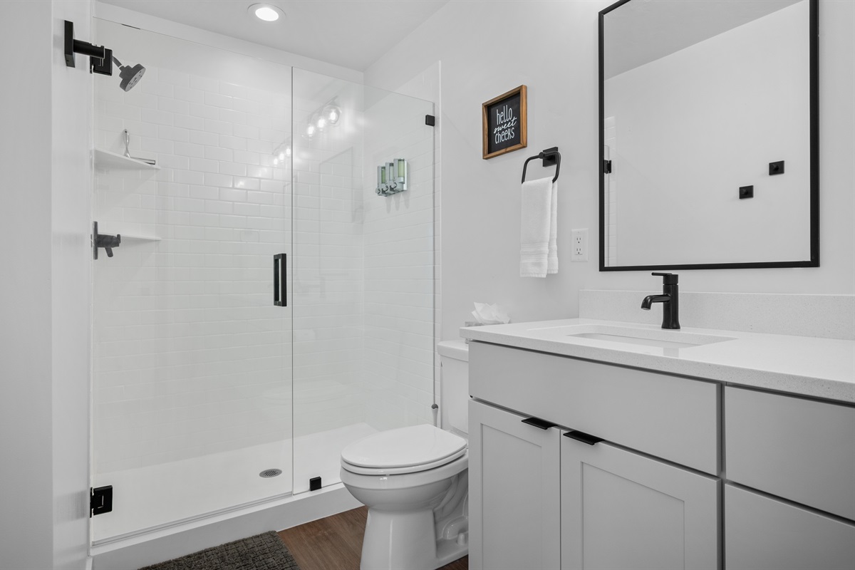 Primary ensuite bathroom with walk-in shower and double vanity.