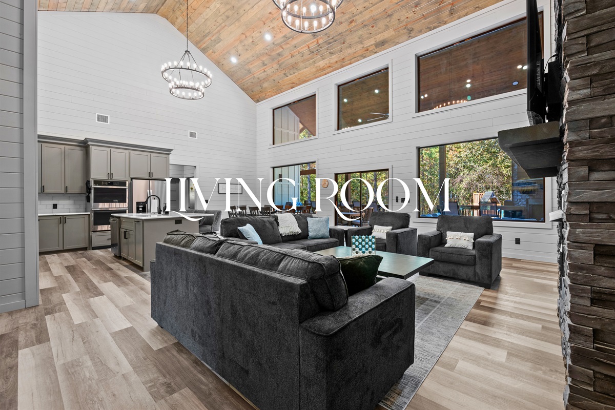 Step inside to a bright, airy living room that instantly makes you feel at home with vaulted ceilings and soft, inviting furniture.