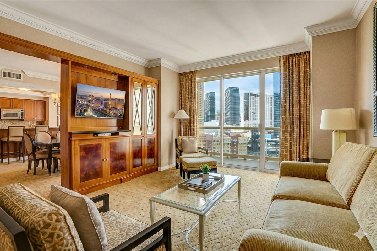 Spacious living room with floor-to-ceiling windows and skyline views! 