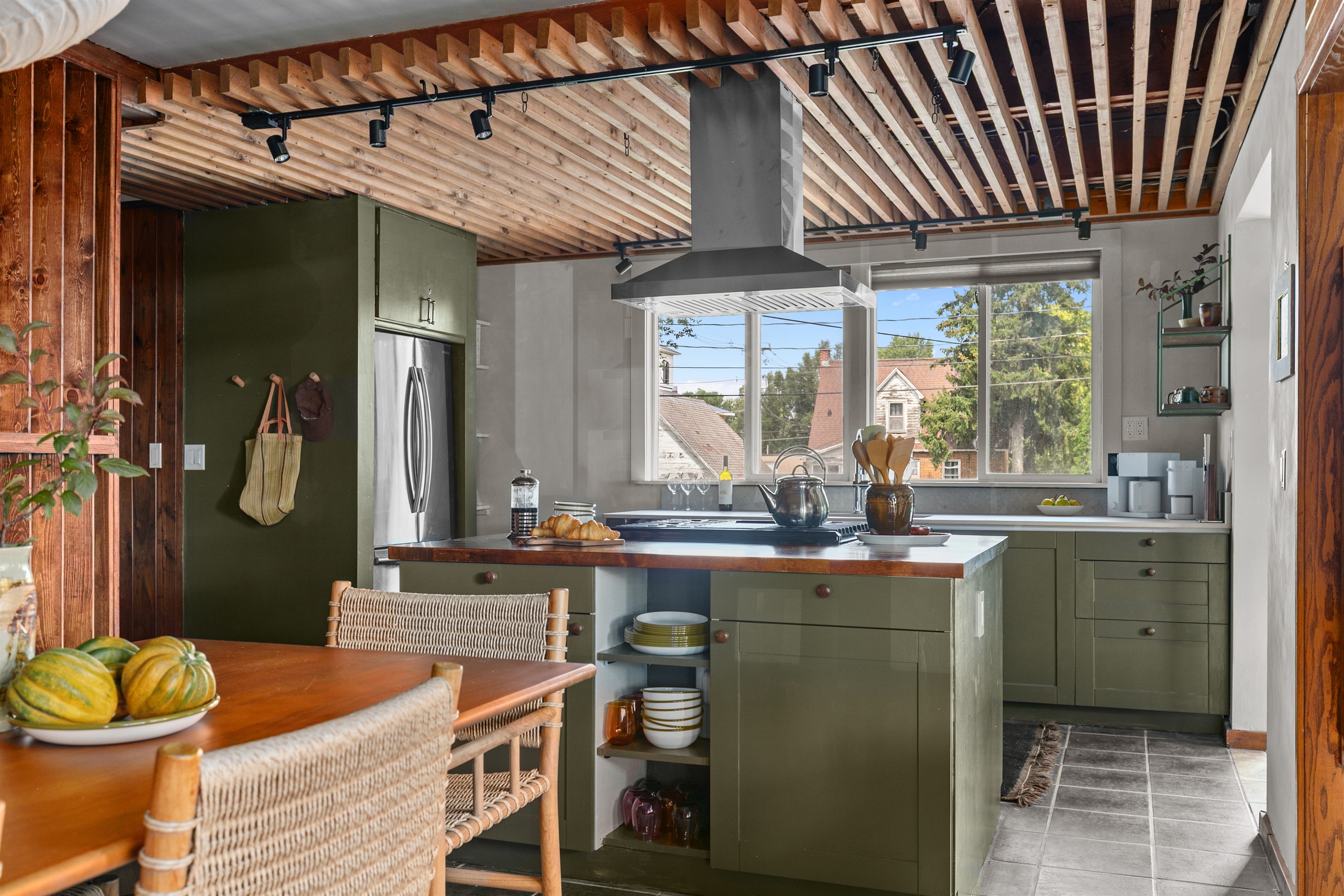 The sleek stove hood makes cooking easy and enjoyable while keeping the space fresh