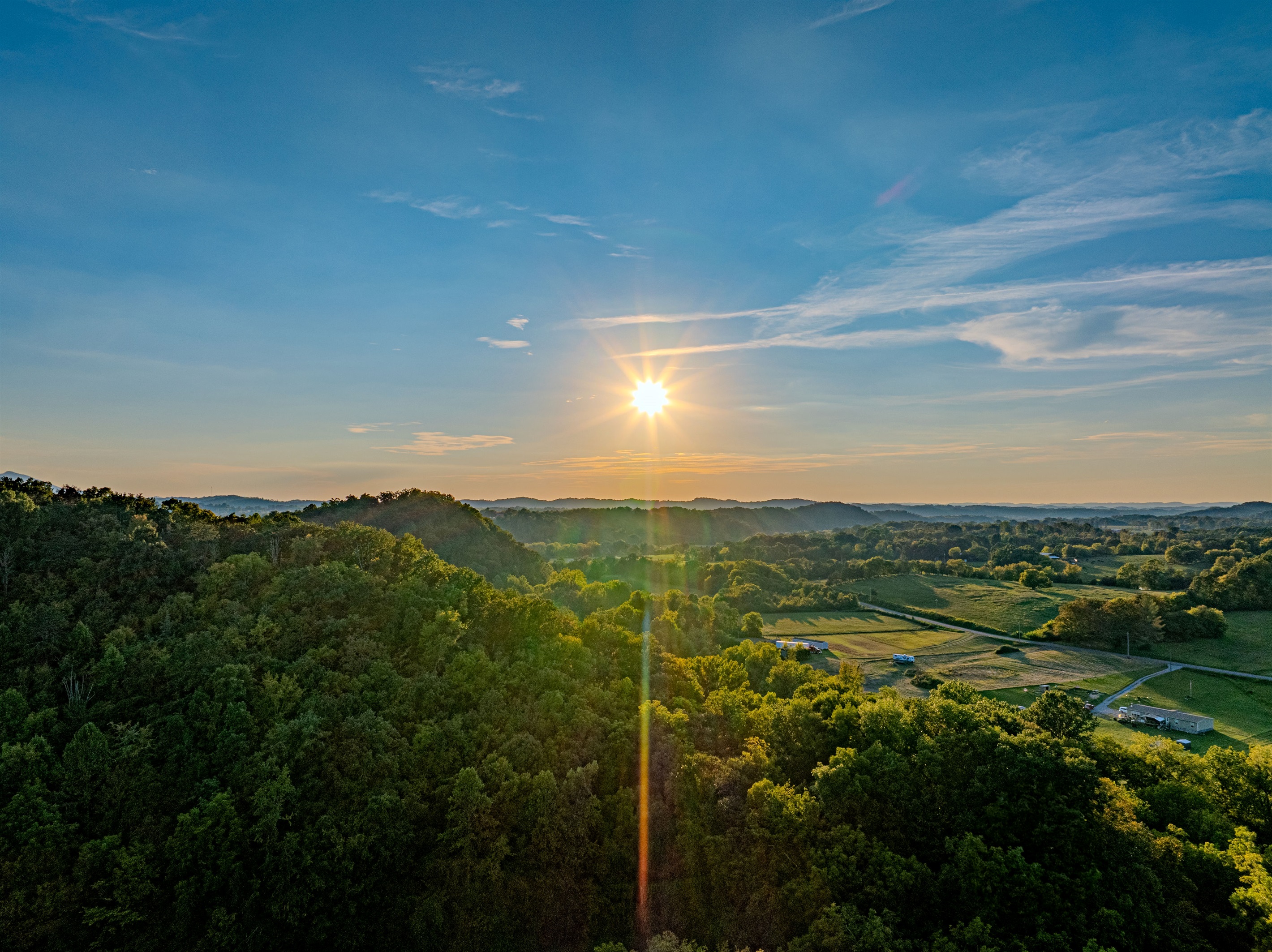 Golden Hour on the Horizon. The true beauty of the Smokies is revealed at sunset. This sweeping, high-altitude view captures the lush landscape that surrounds your unique glamping destination.