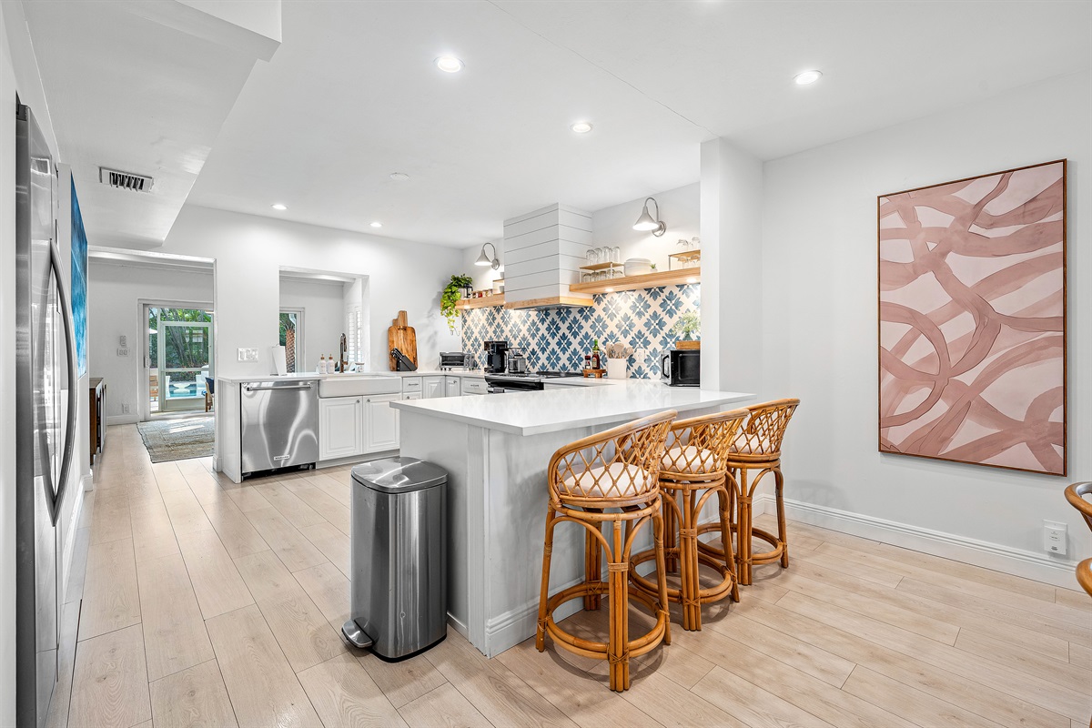 Your culinary adventures await! The spacious kitchen island offers extra seating for casual meals and a central hub for entertaining, featuring modern design.