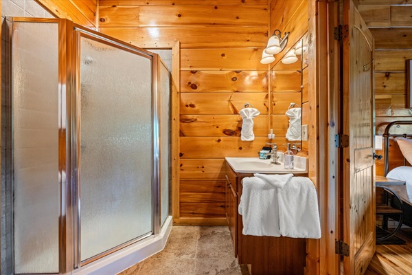 Shower access from both the bedroom and theater room makes mornings simple.