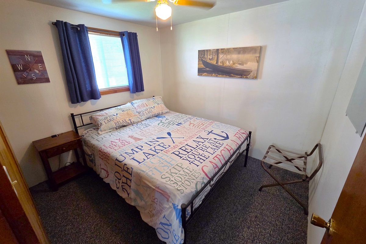 Bedroom 2 features a queen sized bed and ceiling fan.
