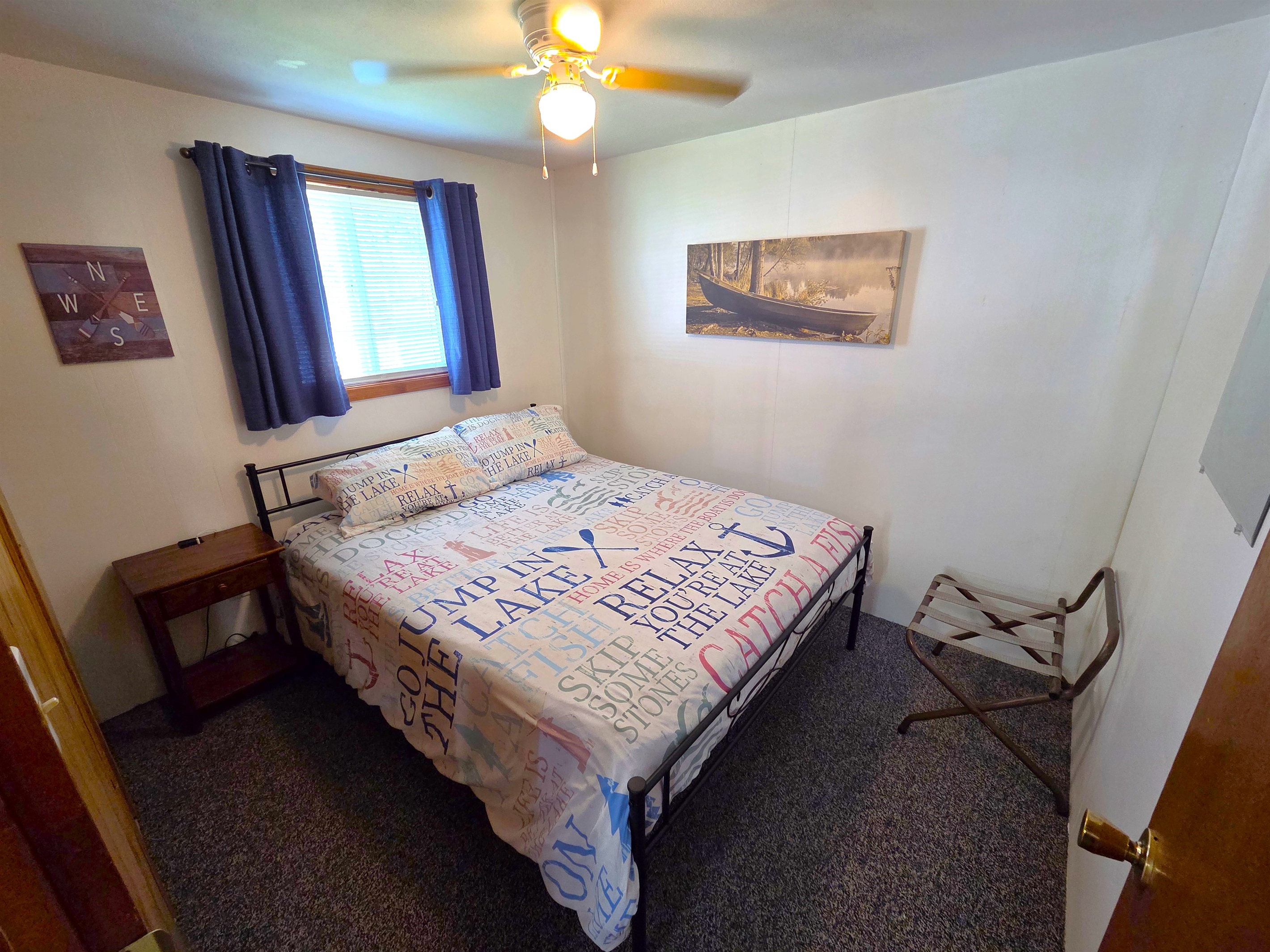 Bedroom 2 features a queen sized bed and ceiling fan.