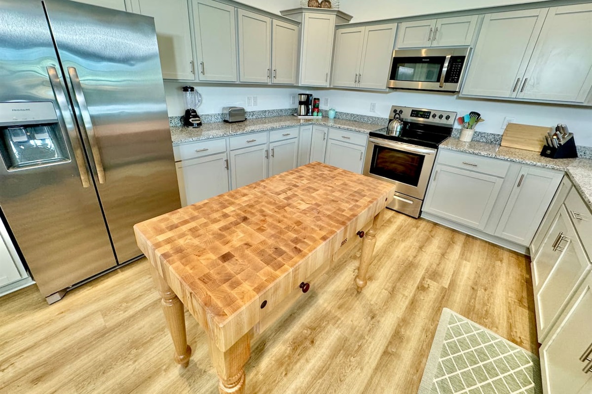Enjoy cooking in this fully stocked kitchen with a custom island and ample bar seating. 