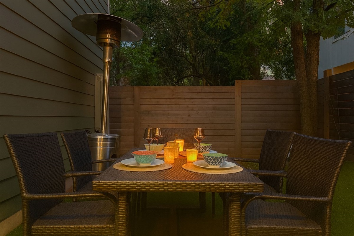 outdoor dining at turf grass yard, with gas lamp heater, warm and cozy even in winter