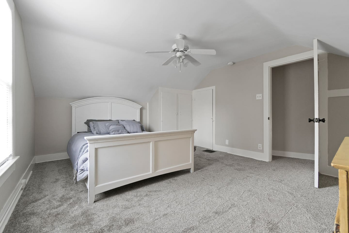 Cozy queen-sized bed with soft, high-quality linens and plush pillows, offering a comfortable and restful retreat for a peaceful night's sleep.