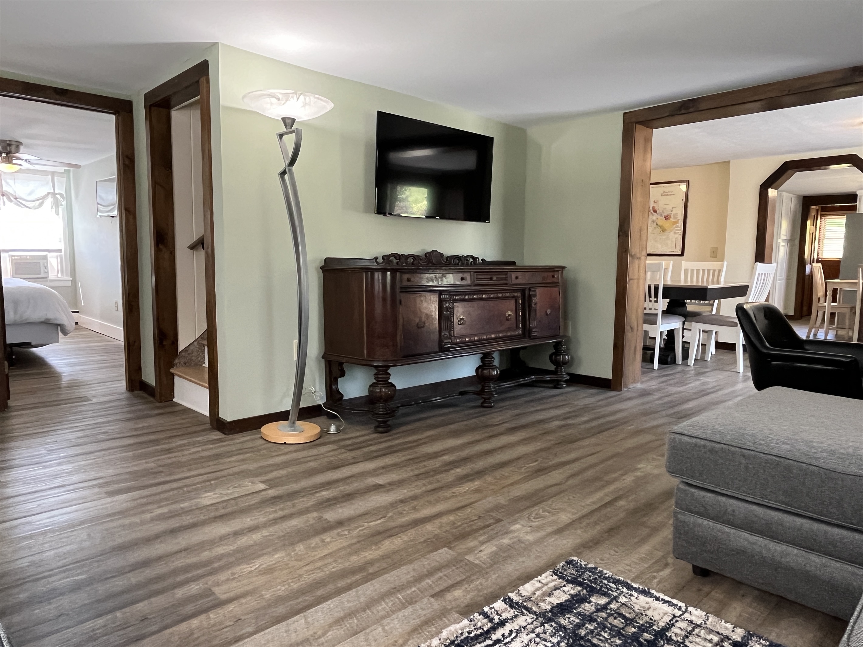 Roundtripper main living room with large smart TV. Note the relative location of the 1st king bedroom and formal dining room.