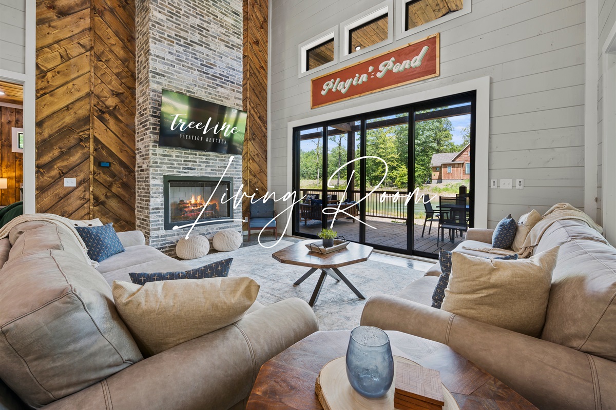 Sink into our plush sofas and let the warmth of the fireplace wrap around you in this inviting living room space.