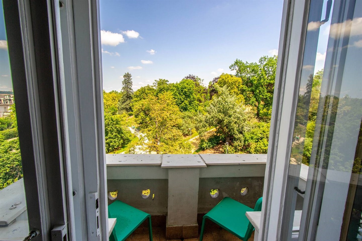 There is a balcony in the apartment with beautiful park view.