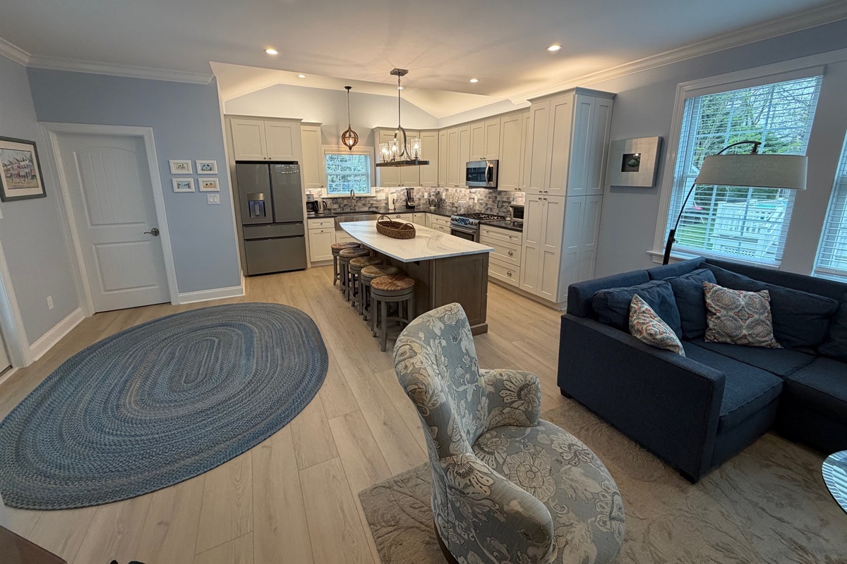 Living room and kitchen after addition.   The powder room is behind the door.