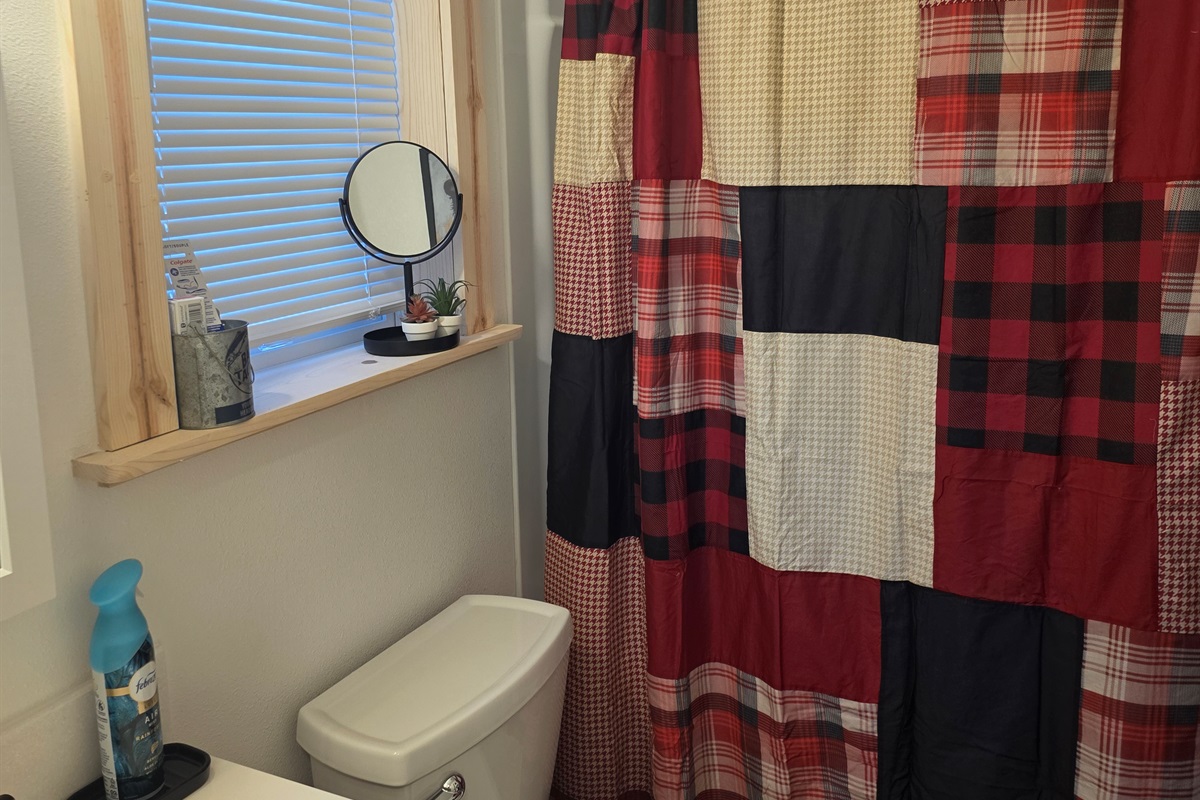 Bathroom includes a vanity, toilet, and shower/tub combo.