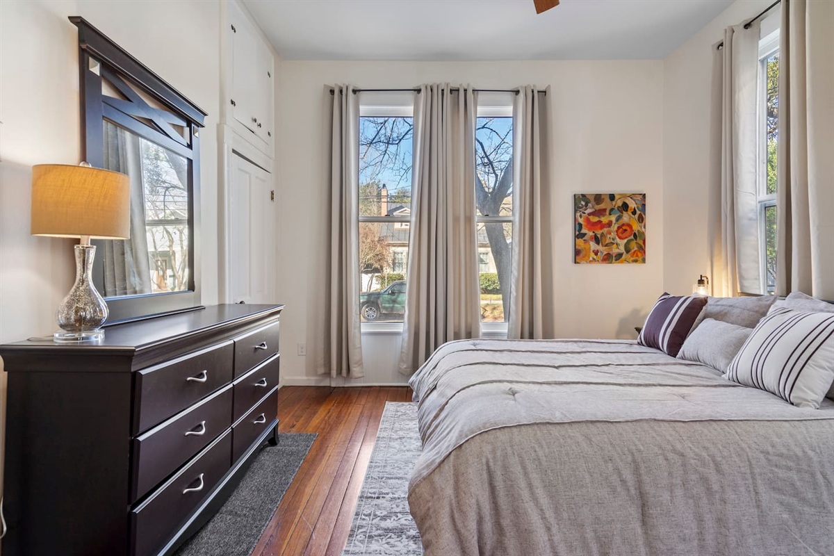 Queen bed with fresh linens — warm, quiet, and full of historic character