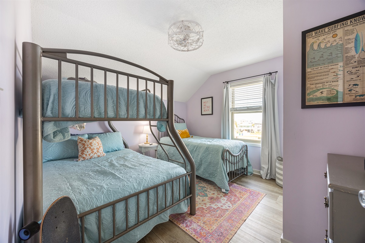Guest bedroom with bunk beds, extra twin, TV, and Xbox—perfect for families.